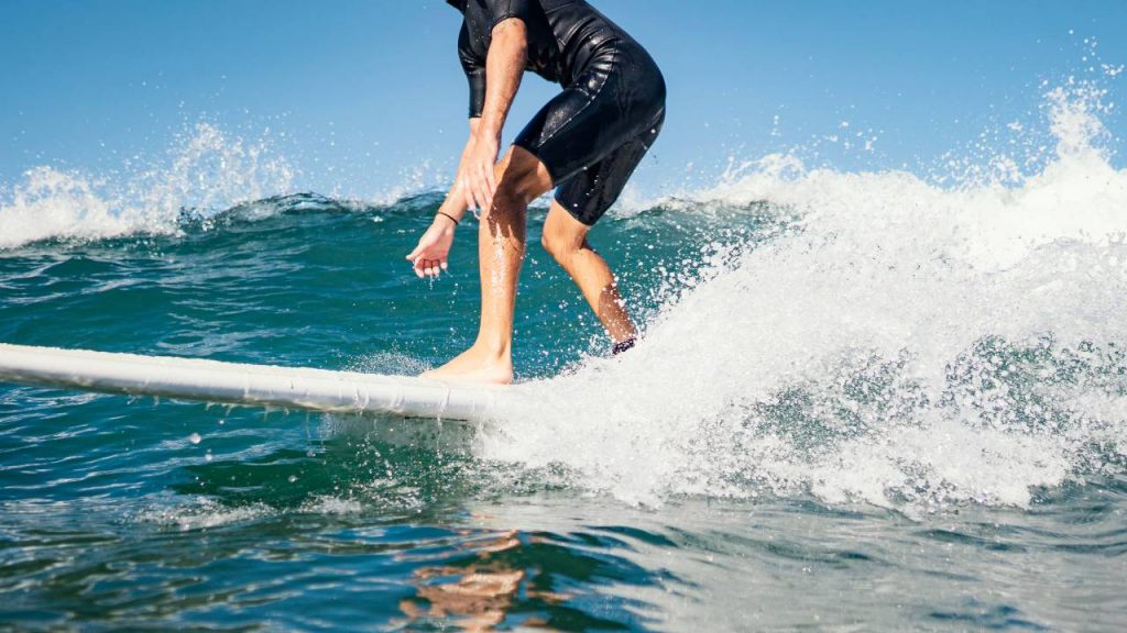 A man surfing as top of the list for COVID stag party ideas