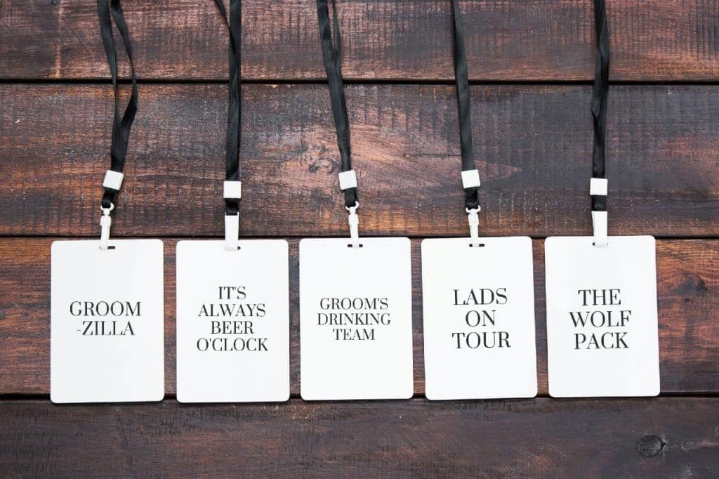 Five stag do badges with slogans on them